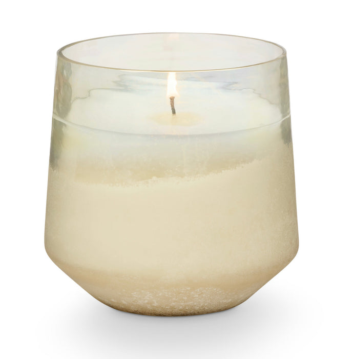 Winter White holiday candle by Illume. Fragrance grounded in warm cardamom with a heart of evergreen kissed with a light sparkling citrus. Clean burning, plant-based candle hand poured into a sanded champagne tinted glass vessel. 13 oz/ approximate 55 hour burn time.