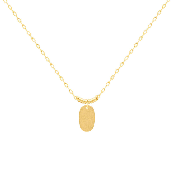 A delicate gold chain necklace with a small, hammered oval pendant, displayed against a solid white background. 18k gold over brass. 16" length with 2" extender.