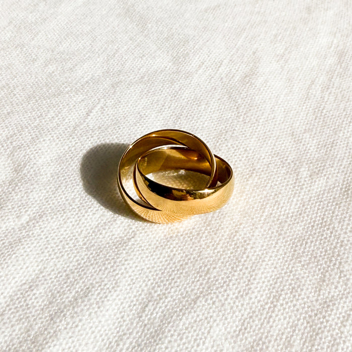 Interlocking gold band rings. Made of stainless steel with gold plating. Water, sweat and tarnish resistant.