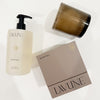 LAVUNE Santal fragrance collection. Candle in a smokey glass vessel with a taupe box and hand wash in a frosted bottle. Each sold separately.