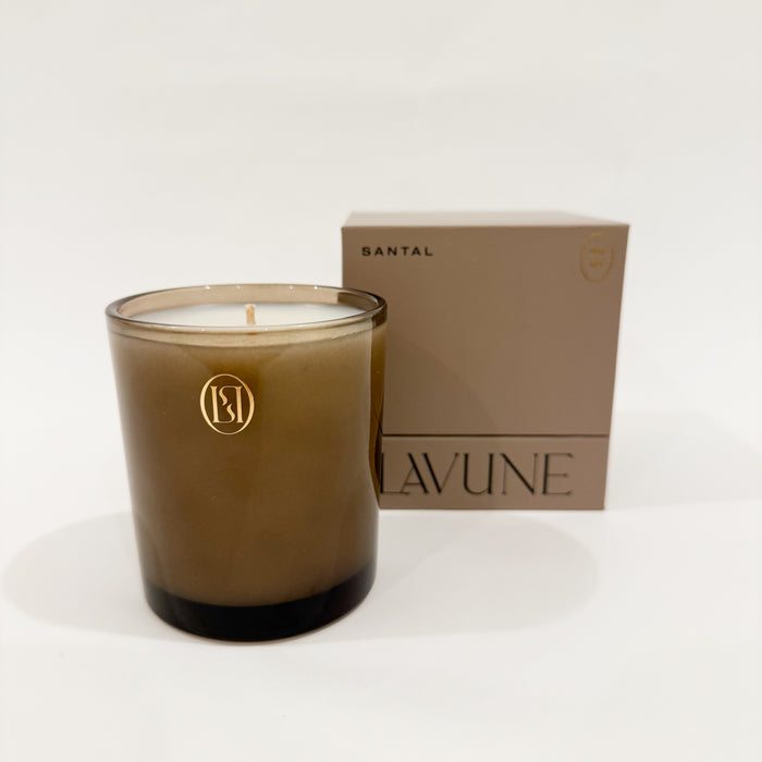 LAVUNE Santal scented candle in a rich taupe glass vessel with coordinating taupe  box on white background.