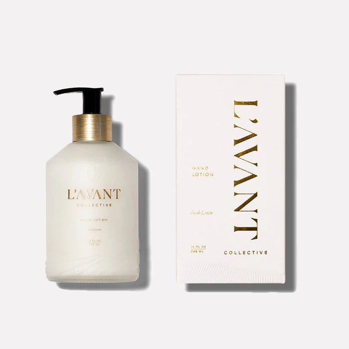 Bottle of L'AVANT fresh linen hand lotion and box . Both  in white with gold lettering. 10 fl oz/ 295ml.