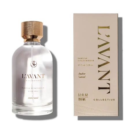 L'AVANT Ambre Santal room spray in clear glass bottle with gold lid and taupe packaging on a white background. 3.3 fl oz, 100ml.