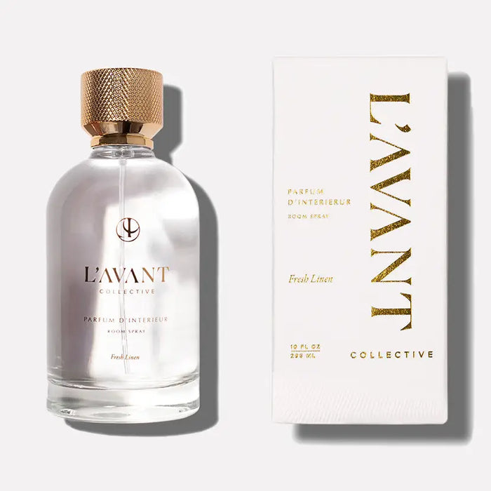 L'Avant Collective Fresh Linen room spray in clear glass bottle with gold cap and white packaging on a white background. 3.3 fl oz, 100ml.