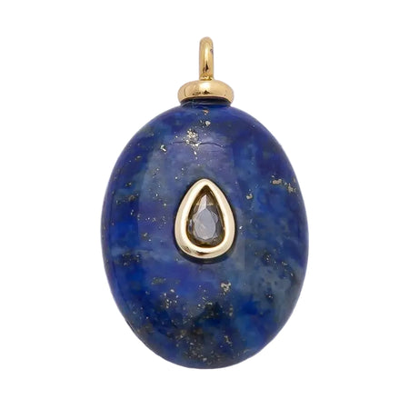 An oval blue lapis lazuli pendant with gold accents, featuring a teardrop-shaped clear stone in the center and a gold bail at the top. 18k gold filled over brass. 24.9mm x 14.9mm