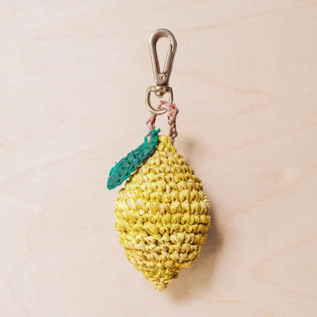 Lemon bag charm hand crocheted in raffia with gold lobster claw clasp.