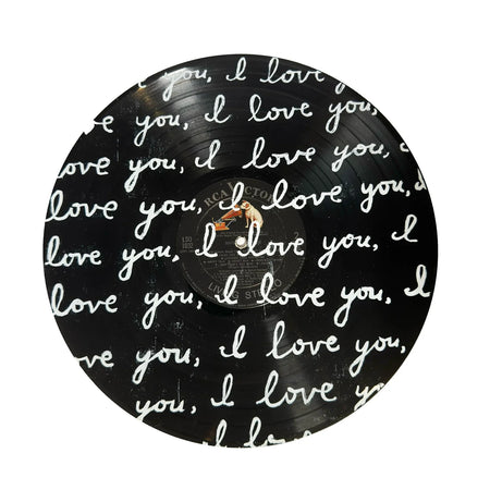 Vinyl record with 'I love you' text in cursive on a white background