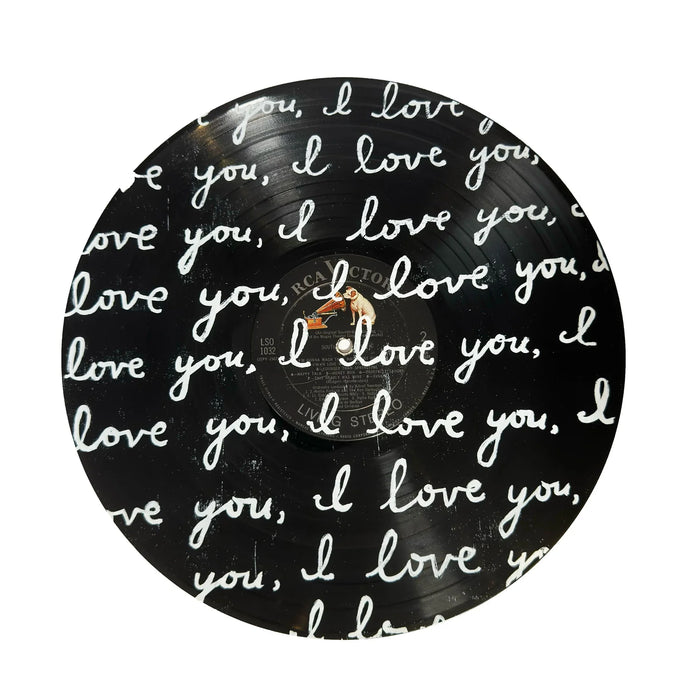 Vinyl record with 'I love you' text in cursive on a white background