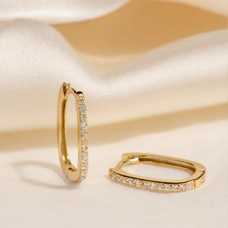 Delicate hinged gold oval hoops with sparkling micro pave' stone detail. 18k gold over 925 sterling silver, CZ stones.
