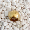 A bold domed ring with a brushed gold finish on white pebbles. 18k gold over brass.