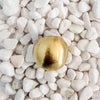 A bold rounded brushed gold ring on white pebbles. 18k gold over brass.