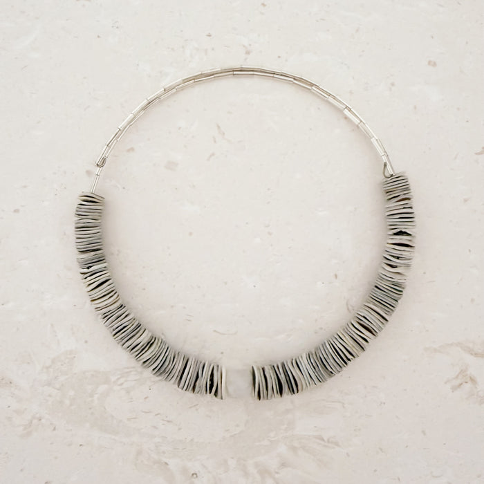 Flexible collar necklace strung with natural shell discs and centered with a chunky Moonstone. Flexible, fits most necks.