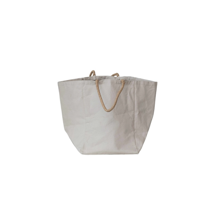 Tote made of unbleached heavy duty cotton canvas with a waxed interior and natural woven jute handles. An everyday essential perfect for storing blankets and toys or used in the car hauling groceries. Medium 12" square x 15" height.