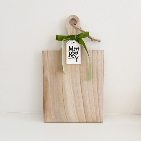 Solid light wood charcuterie board ready for gift giving. Comes with a green velvet bow and a Merry Christmas tag. Makes the perfect hostess gift. Measures 17.25" x 10"