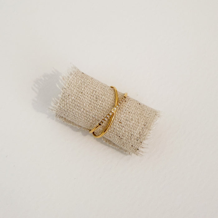 Set of two golden interlocking rings. One is gold, the other has clear CZ stones. Water, sweat and tarnish resistant.