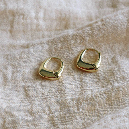 Pair of small gently rounded trapezoid shape hoop earrings. 14K gold plated over brass. 13.5 x 15mm.