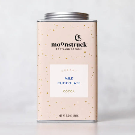 Moonstruck creamy milk chocolate hot cocoa mix in pale pink tin. Contains 8 servings.