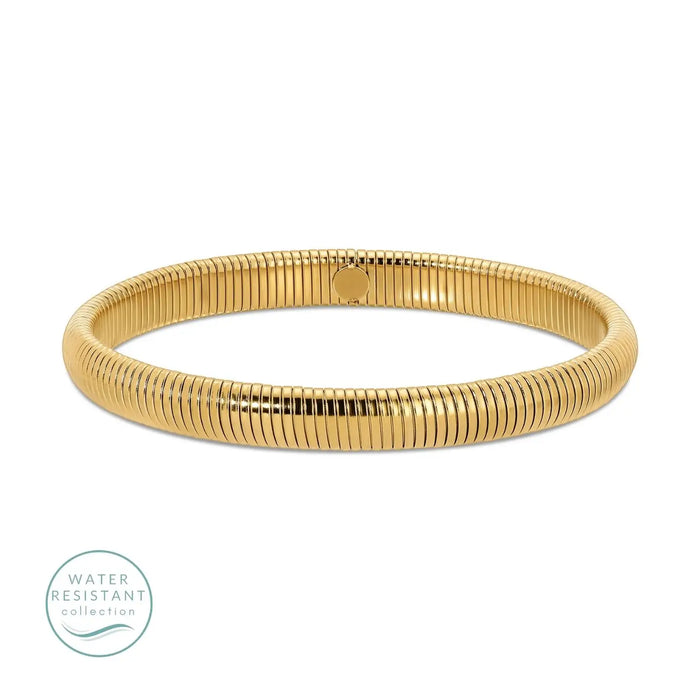 Gold coil bangle. Waterproof. 18K gold PVD plating over premium stainless steel. .31 inch width. 7.5 inch circumference.