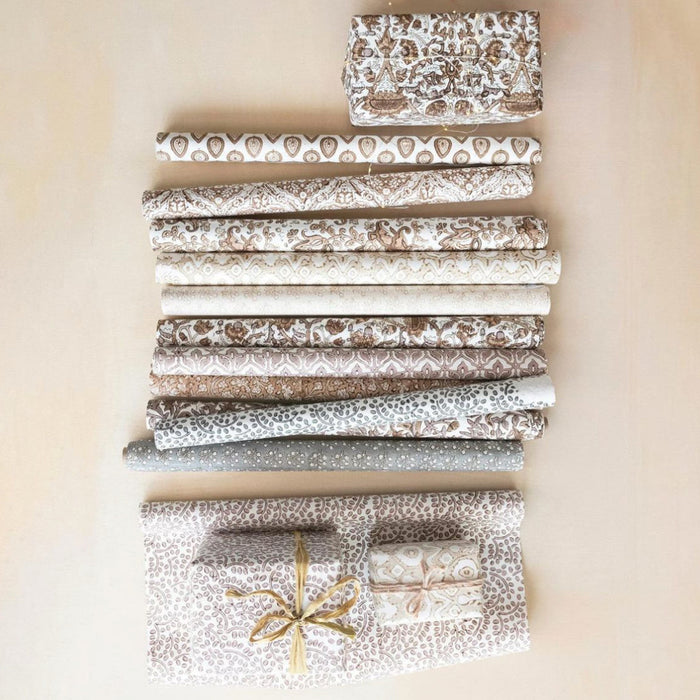 Multiple rolls of woodblock gift wrap, each roll in a different pattern. Each roll contains 3 sheets of the same pattern. Each roll sold separately. 28" x 20"