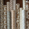 Collection of rolls of woodblock printed gift wrap in soft neutral colors. Each roll is a unique pattern. Each sold separately. 3 sheets per roll, 28" x 20"