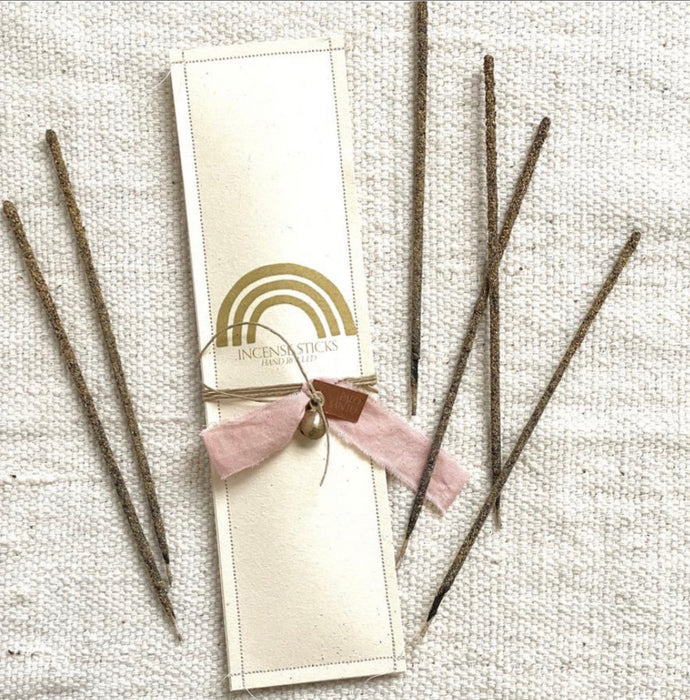 Package of 12 hand rolled Palo Santo incense sticks. Packaged in a hand make paper envelope with a hand dyed blush ribbon and brass charm.