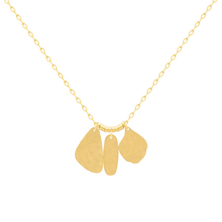 A gold necklace with three flat, hammered organically shaped pendant charms on a delicate chain, shown against a plain white background. 18k gold over brass.