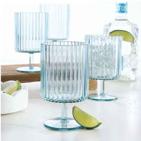 Four fluted acrylic wine goblets in a clear pale blue styled with a bottle and lime wedge. Goblets sold as a set of four.