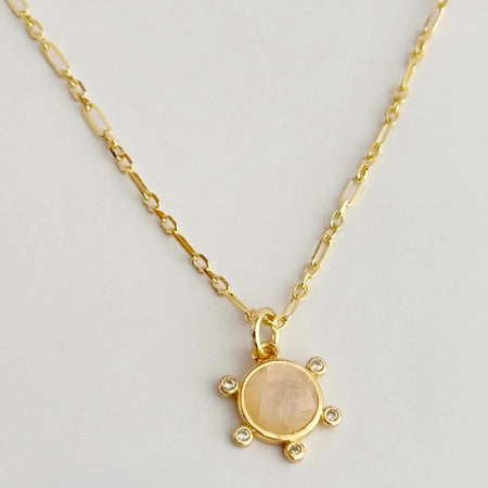 Gold chain featuring a delicate sun pendant crafted in rose quartz surrounded by delicate clear CZ stones. 925 Sterling Silver base with gold vermeil plating. 18 inch length.
