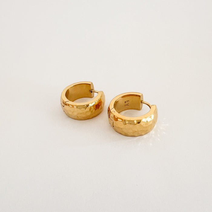 The Reese hoop earrings are a small scale chunky clicker hoop with a reflective hammered finish. 14k gold plating with protective coating on a hypoallergenic marine grade stainless steel base. Water, sweat and tarnish resistant.