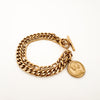Rhodes double chain bracelet. Classic double layer chain bracelet with toggle closure and a vintage inspired coin charm. Made of gold plated marine grade stainless steel with protective coating. Water, sweat and tarnish resistant. Designed to hold up to a modern, active lifestyle by Ellie Vail. 
Measures 7.5 inches.