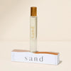 Roll-on perfume bottle of SAND fragrance with matching box. Fragrance notes of Santal, Cedarwood, Sweet Cardamom and Vanilla. 10 mL