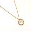 Delicate gold chain necklace with a flat white mother of pearl medallion framed in gold. 18 inch length. Water, sweat and tarnish resistant.