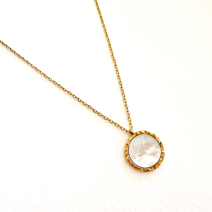 Delicate gold chain necklace with a flat white mother of pearl medallion framed in gold. 18 inch length. Water, sweat and tarnish resistant.