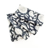 Set of 4 folded floral print napkins in a rich indigo and cream woodblock print. 18 inch square.