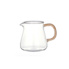 Clear glass pitcher with a rattan wrapped handle on a white background. Holds 20 fl oz.
