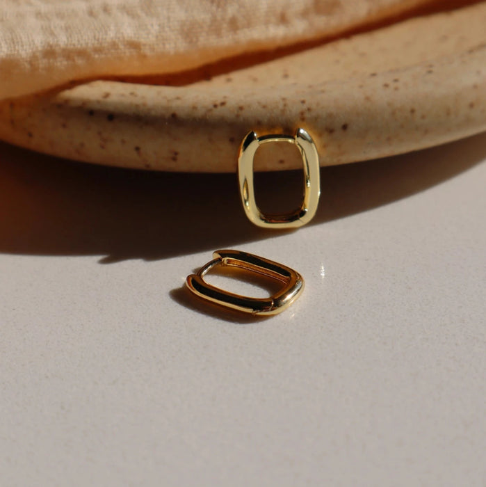 Pair of small gold oval shaped hoop earrings. 14K gold plated over silver. 11 x 14m.
