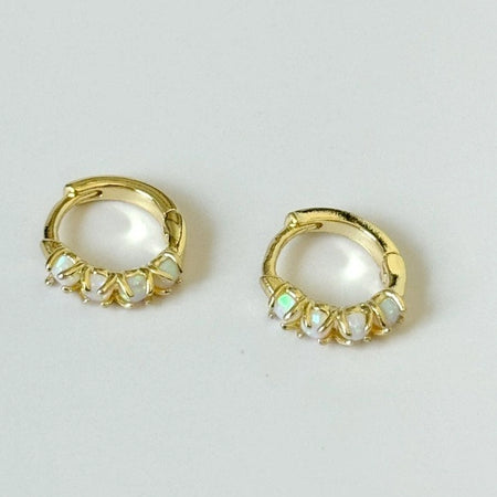 Pair of delicate gold plated huggie hoop earrings adorned with four small Opal stones. Gold plated over brass.