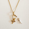 Delicate 18K gold filled chain with oval hinged pendant holding a palm tree charm and a trio of pearls. Charms sold separately.