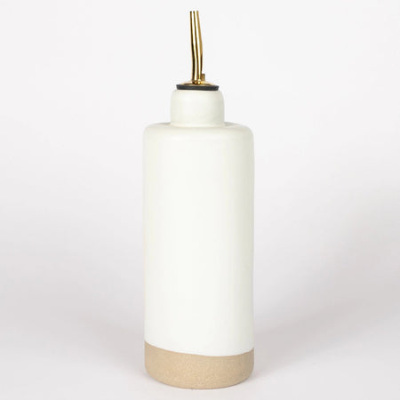 A white stoneware olive oil cruet with a matte finish and a gold-colored spout. 11 inch height, including spout. 3 inch diameter.