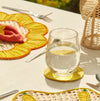 Outdoor table setting featuring lemon slice coasters and other woven decorative objects. Sold as a set of 4.