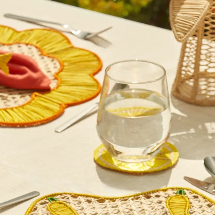 Outdoor table setting featuring lemon slice coasters and other woven decorative objects. Sold as a set of 4.