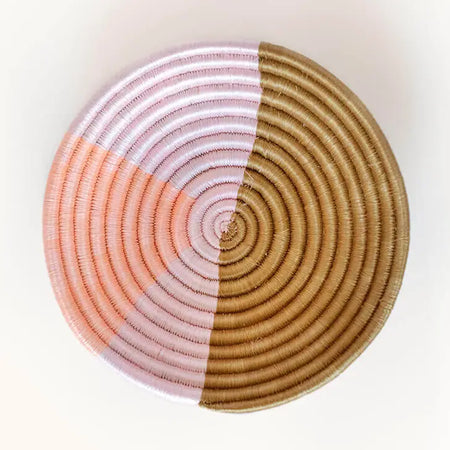 Small round basket bowl hand woven in natural sweetgrass with an abstract pattern of coral and blush. 8 inch diameter x 2 inch.