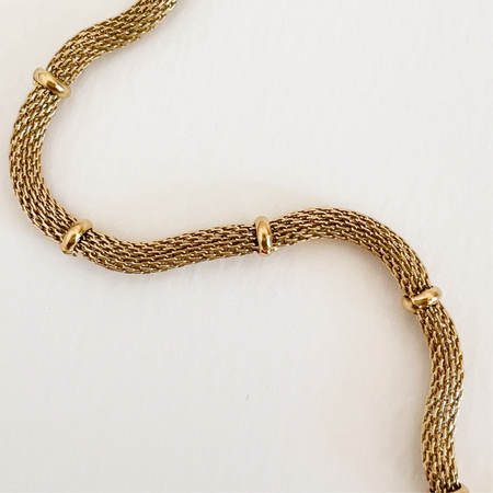 Close up detail of the golden mesh clamped with small gold rondells. 18" length necklace.