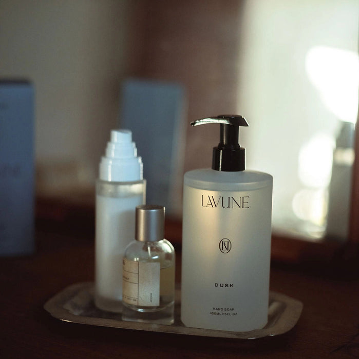 LAVUNE hand wash and other skincare products styled on a tray with a blurred background.