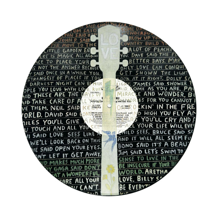 Vinyl record with a painted guitar design and song quotes in white text.