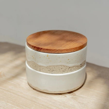 Set of Wabi ramekins. Two round stackable speckled stoneware containers with a creamy white glaze. Use to hold butter, charcuterie spreads or as a trinket dish. Measures 4" diameter, 3.25" total height, each dish is 1.5" height.