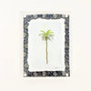 Framed watercolor of a palm tree with decorative indigo and white block print matter in a clear lucite block. Measures 6" x 8"