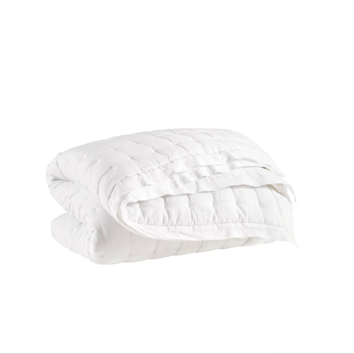 White luxe linen quilt by Annie Selke. The face is  100% linen, the reverse is a soft silky rayon. Lightly padded and quilted in a modern box pattern. Perfect for a lofty, layered bed. Available in Full/Queen 102 x 95 inches and King 118 x 95 inches.