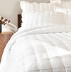 Bed made up in the white luxe linen quilt and shams by Annie Selke. All items sold separately. Quilt has 100% linen face with the reverse in a soft silky rayon. Lightly padded and quilted in a modern box pattern. Quilt available in Full/Queen 102 x 95 inches and 118 x 95 inches.