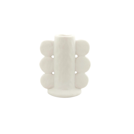 A white scallop ceramic taper candle holder with a matte white glaze.